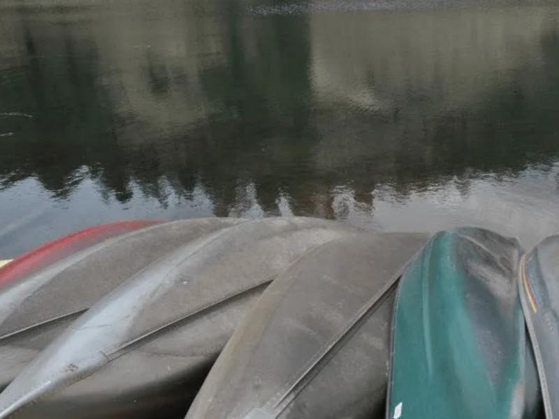 Canoes resting on the shore of the lake