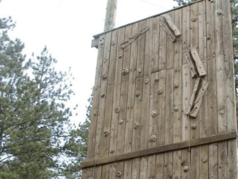 The wooden climbing wall in the forest