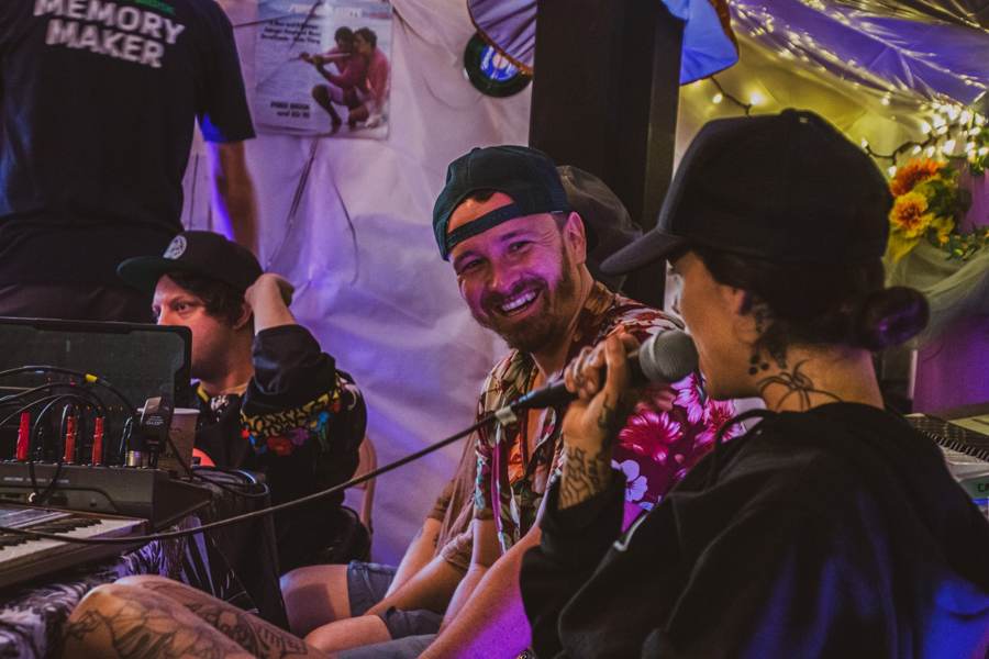 Mentors laughing together at the studio mic station